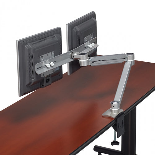 Rear view of the Offices to Go MVL2SDEH dual monitor arm showing the heavy-duty under-desk clamp mounting system and enclosed cable routing channels